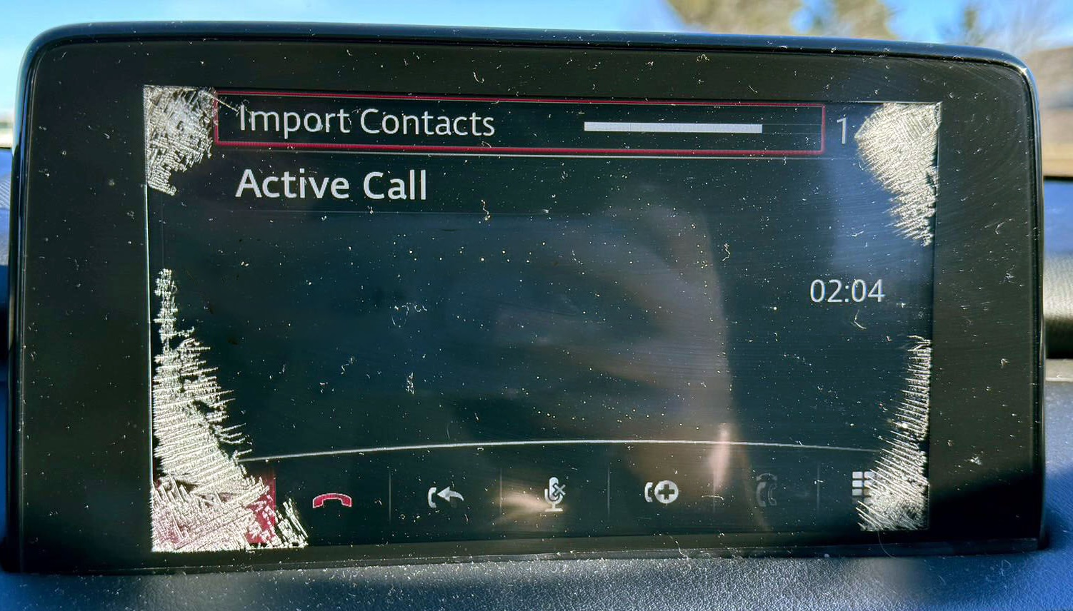 Spider cracks spreading across a Mazda touchscreen